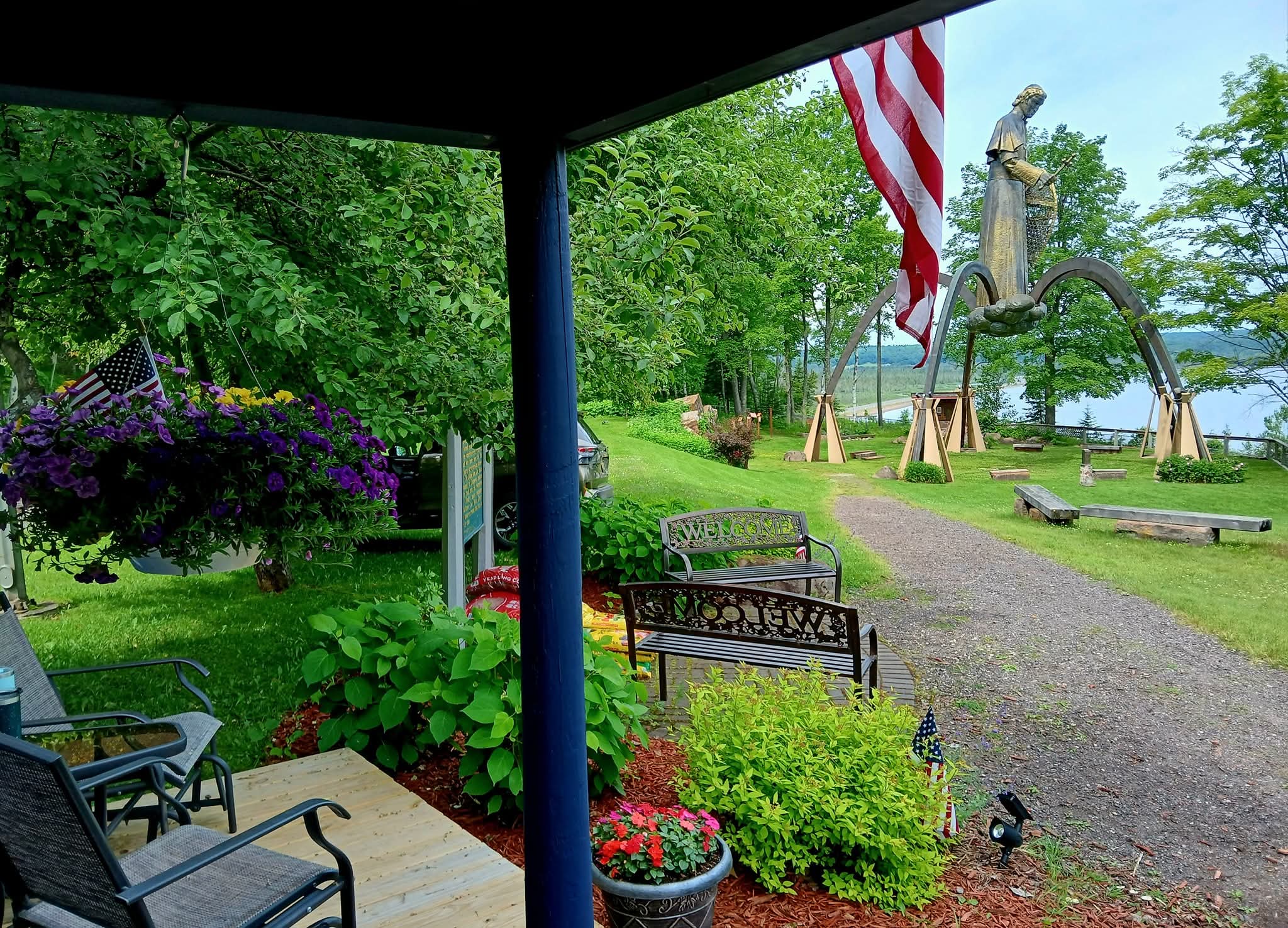 Lake Superior scenic shrine and gift shop with statue in background in summer. Lake Superior scenic shrine and gift shop with statue in background in summer.